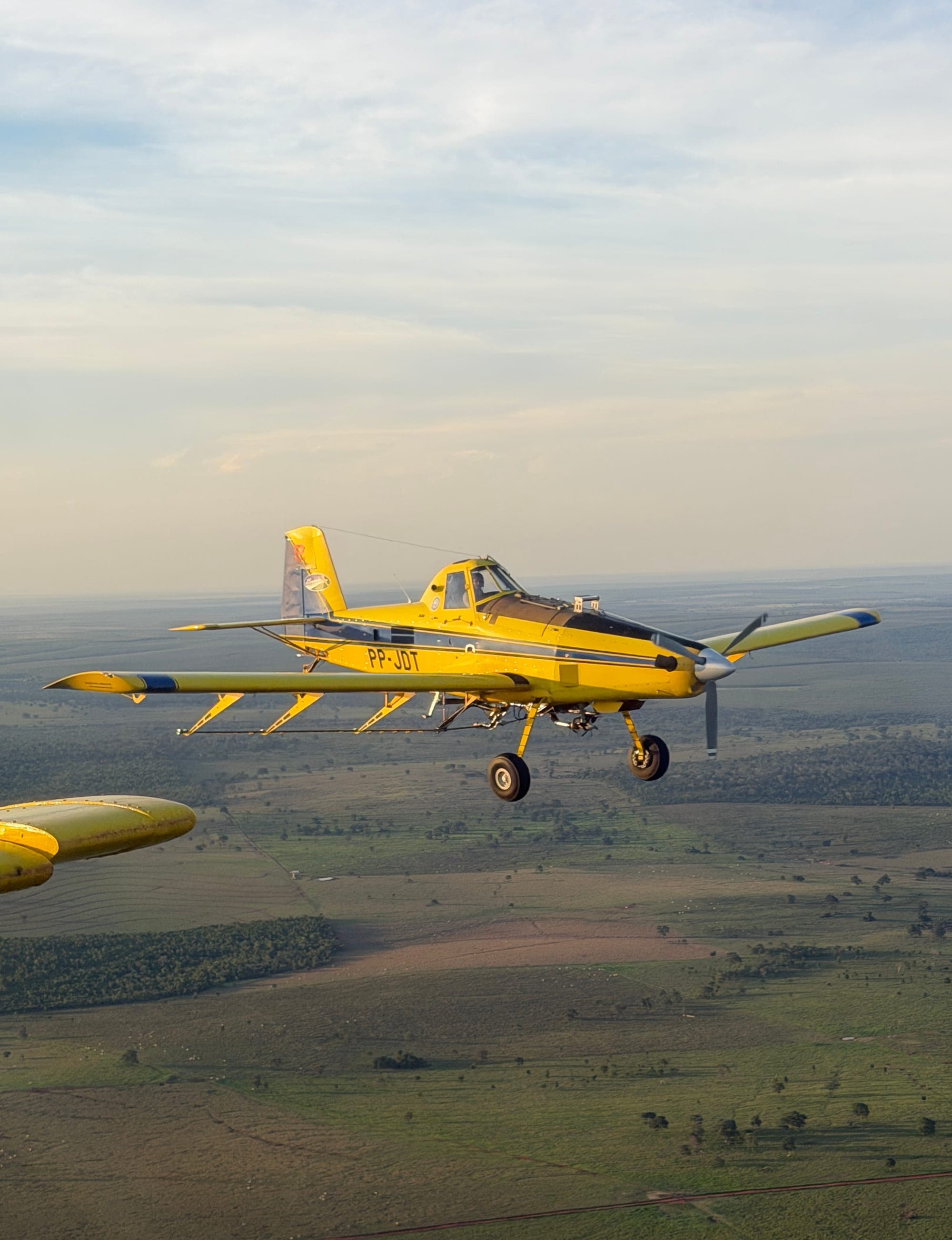 Air Tractor em voo sobre área rural